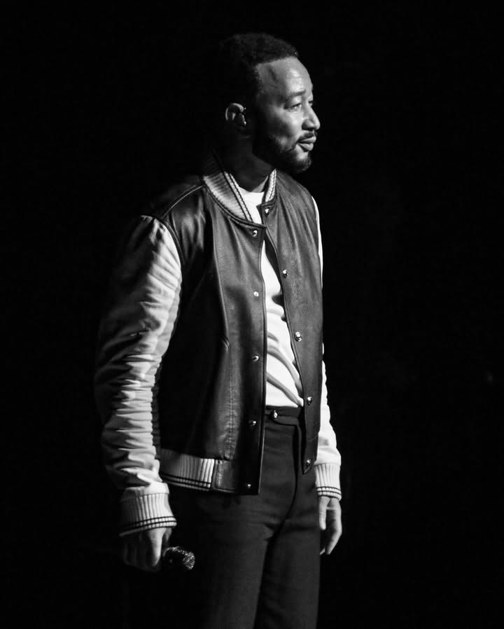 May be a black-and-white image of one or more people, microphone, concert and text