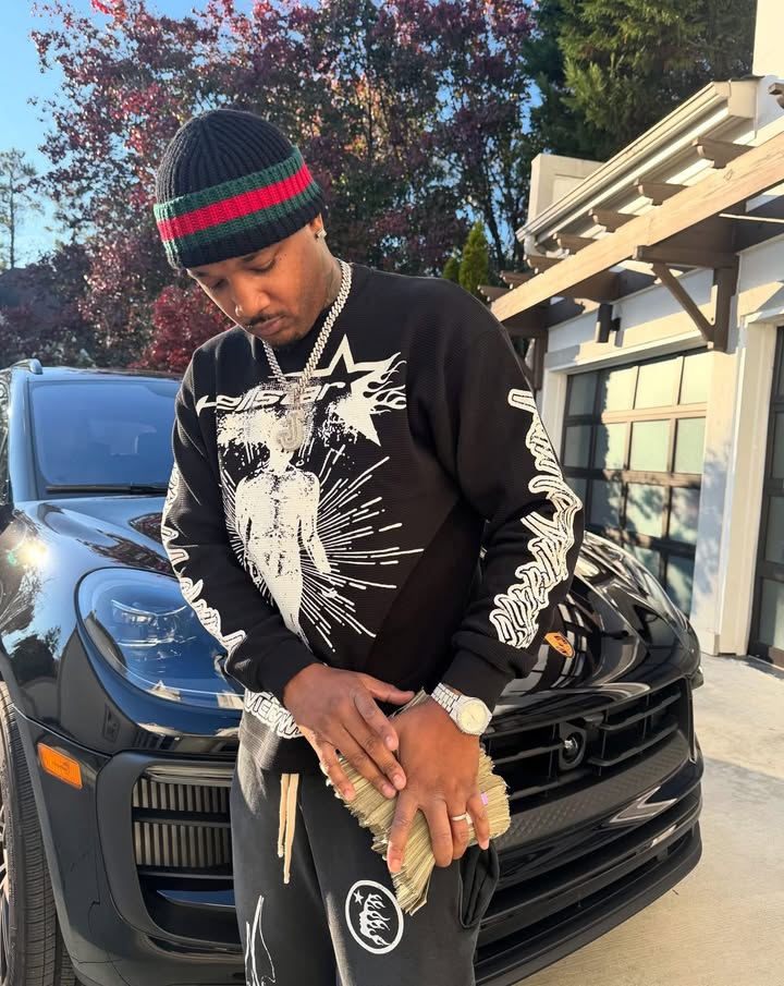 May be an image of standing, sweater, sweatshirt, sweatsuit and text