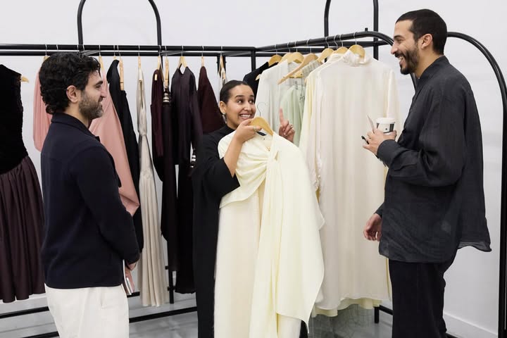 May be an image of suit, gown, dress and text