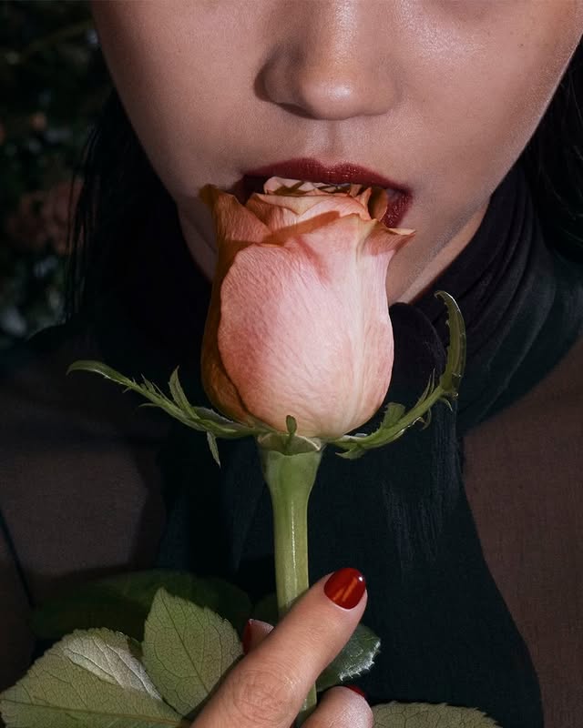 May be a closeup of one or more people, makeup, rose and text