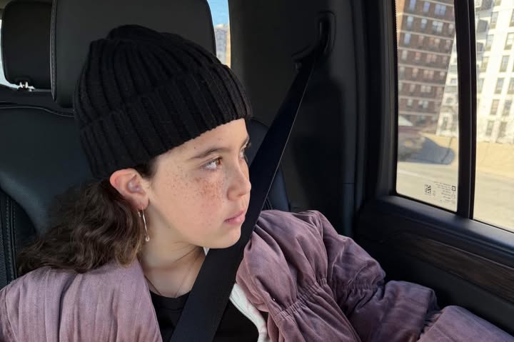 May be an image of one or more people, car, hat, seatbelt, window and text