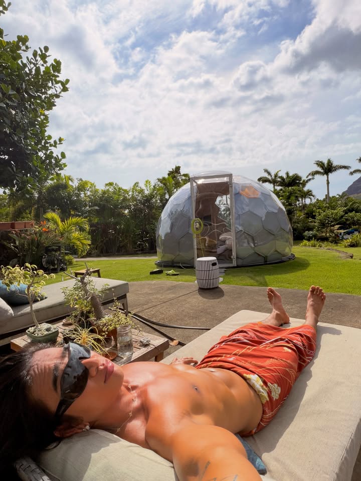 May be an image of sarong, deck chair, pool, outdoors, cabana and text