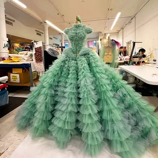 May be an image of gown and text