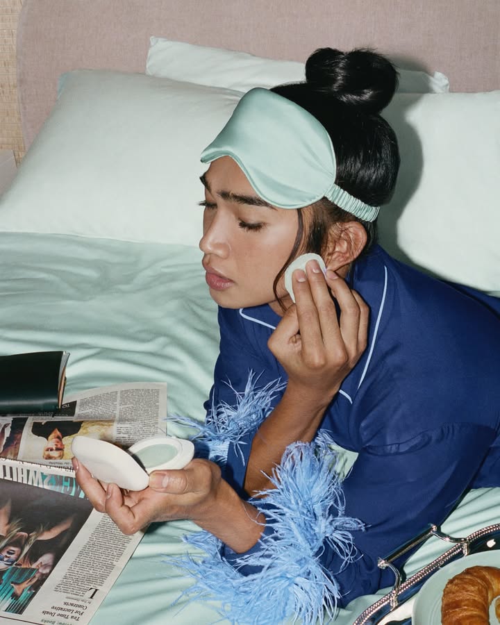 May be an image of one or more people, makeup, sleepwear, bath robe, robe, headscarf and text