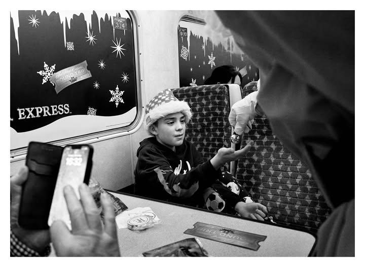 May be a black-and-white image of one or more people, phone, train, hat, cigarette, portable cassette player, telephone, bus and text