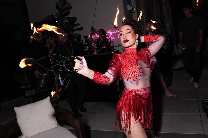 May be an image of dancing, fire, costume and text