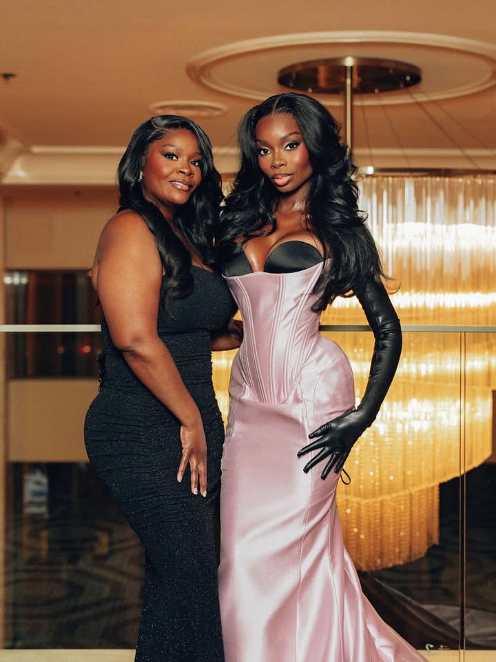 May be an image of one or more people, gown, dress and text