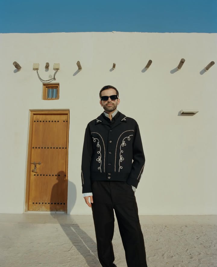 May be an image of suit, eyewear, outerwear and text