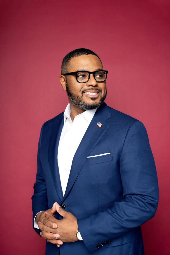 May be an image of one or more people, beard, eyeglasses, suit, blazer, dinner jacket and text