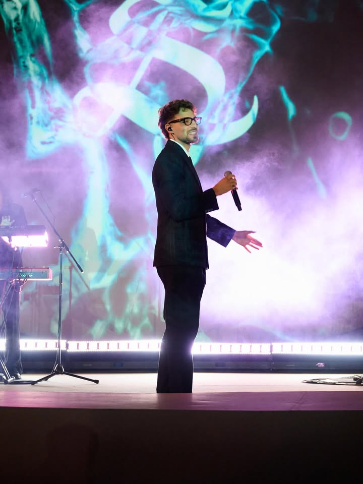 May be an image of microphone, concert and text