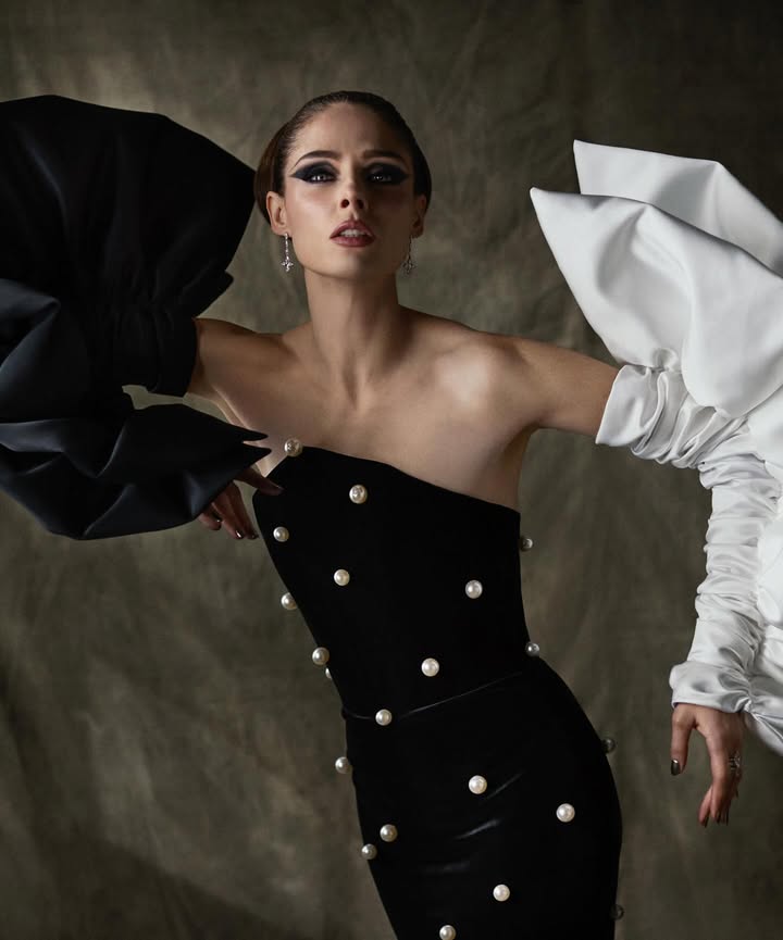 May be an image of one or more people, makeup, gown, dress and text