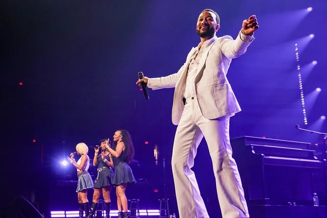 May be an image of blazer, microphone, concert and text