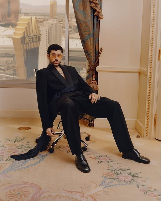 May be an image of overcoat, dinner jacket, magazine, turtleneck, blazer, suit and text