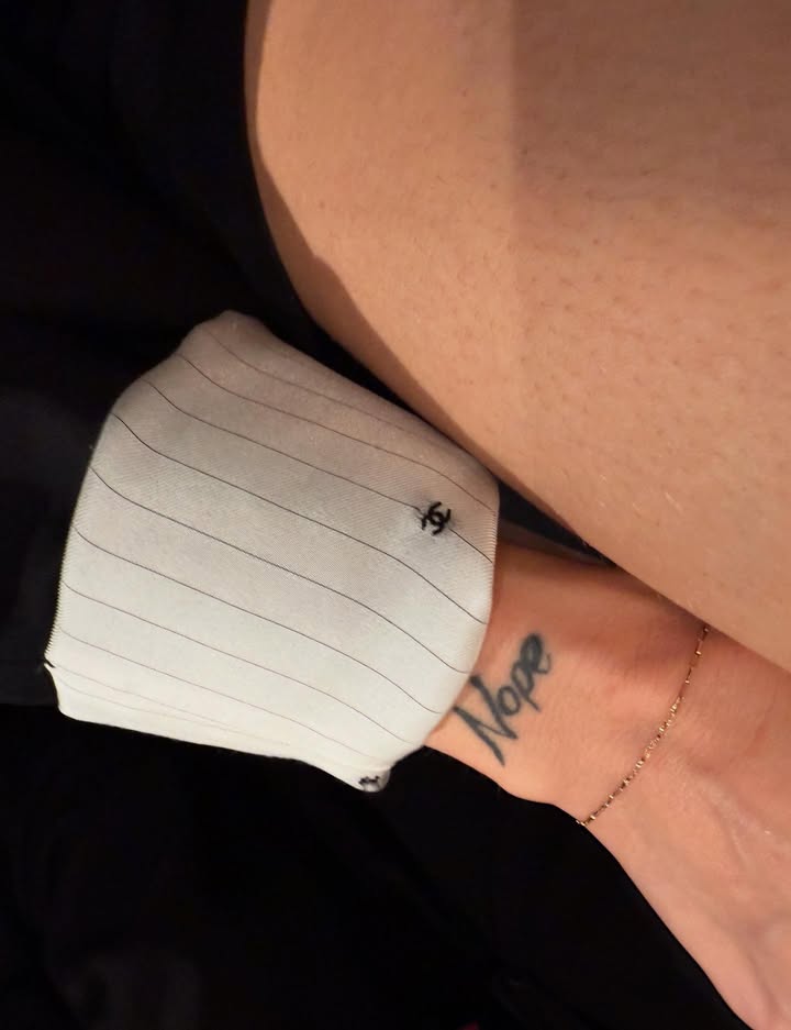 May be an image of one or more people, tattoo, cufflinks, anklet, bandage and text