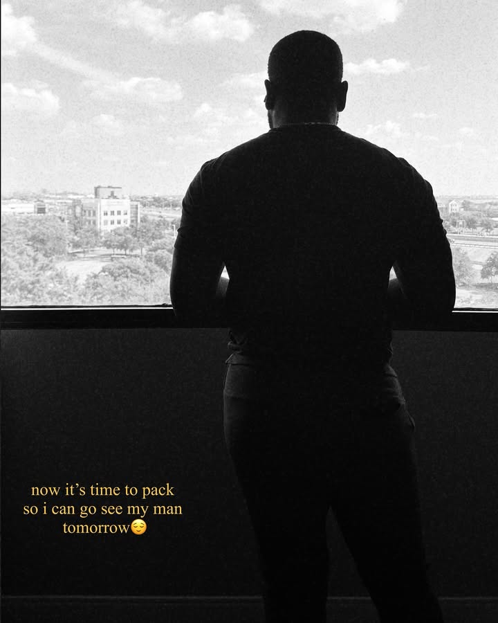 May be a black-and-white image of one or more people, people standing, buildings and window