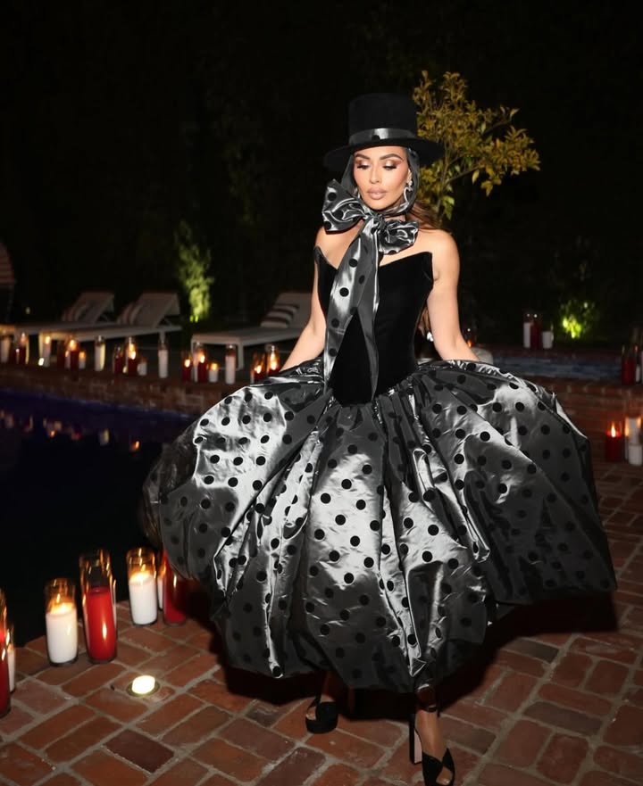 May be an image of headdress, gown, dress and text