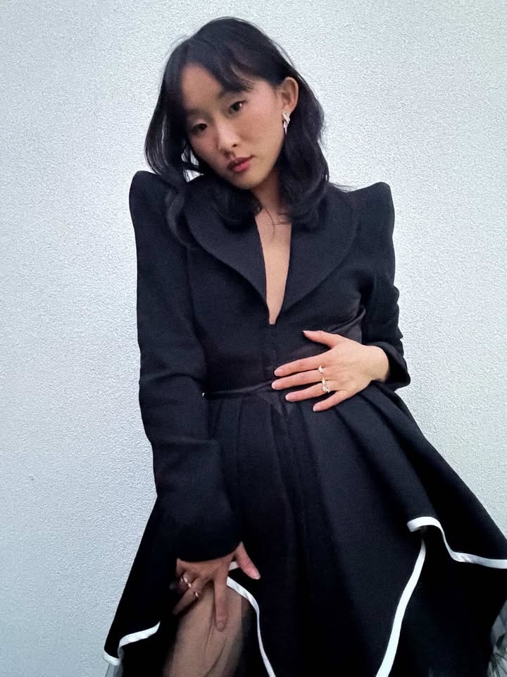 May be an image of duffle coat, overcoat, blazer, dress and text