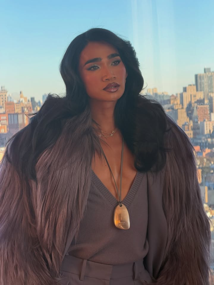 May be an image of one or more people, eyeliner, makeup, sable coat, necklace and text