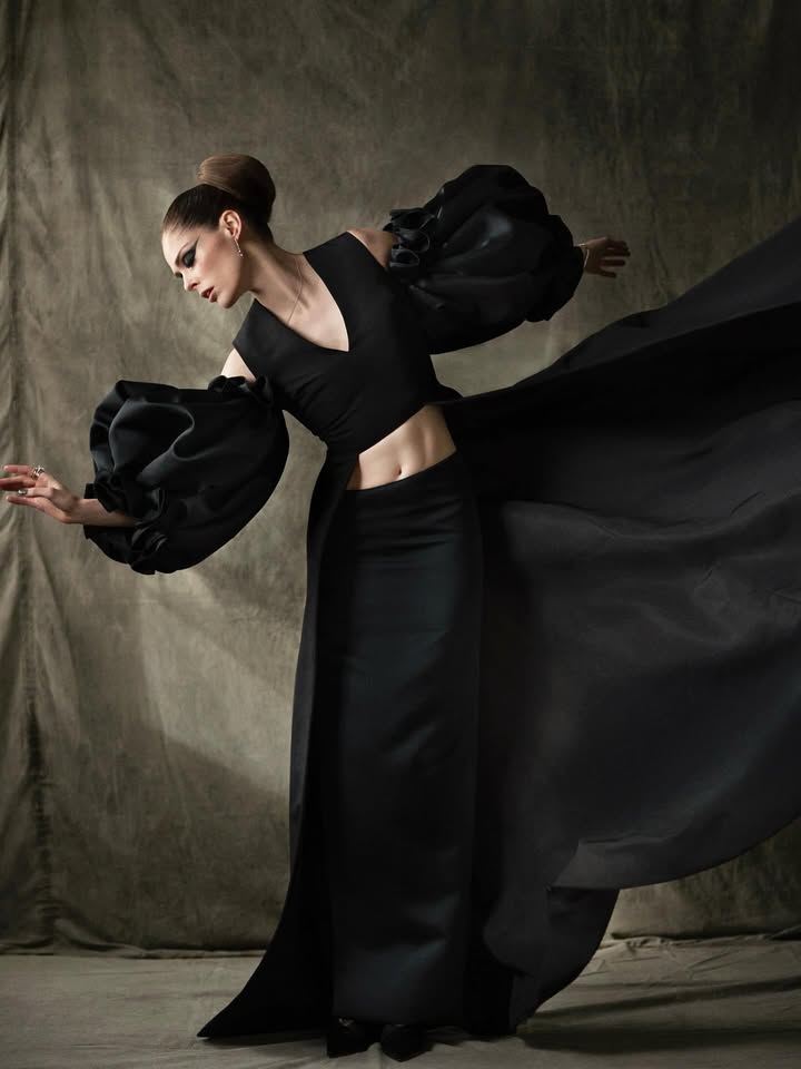 May be an image of gown and text