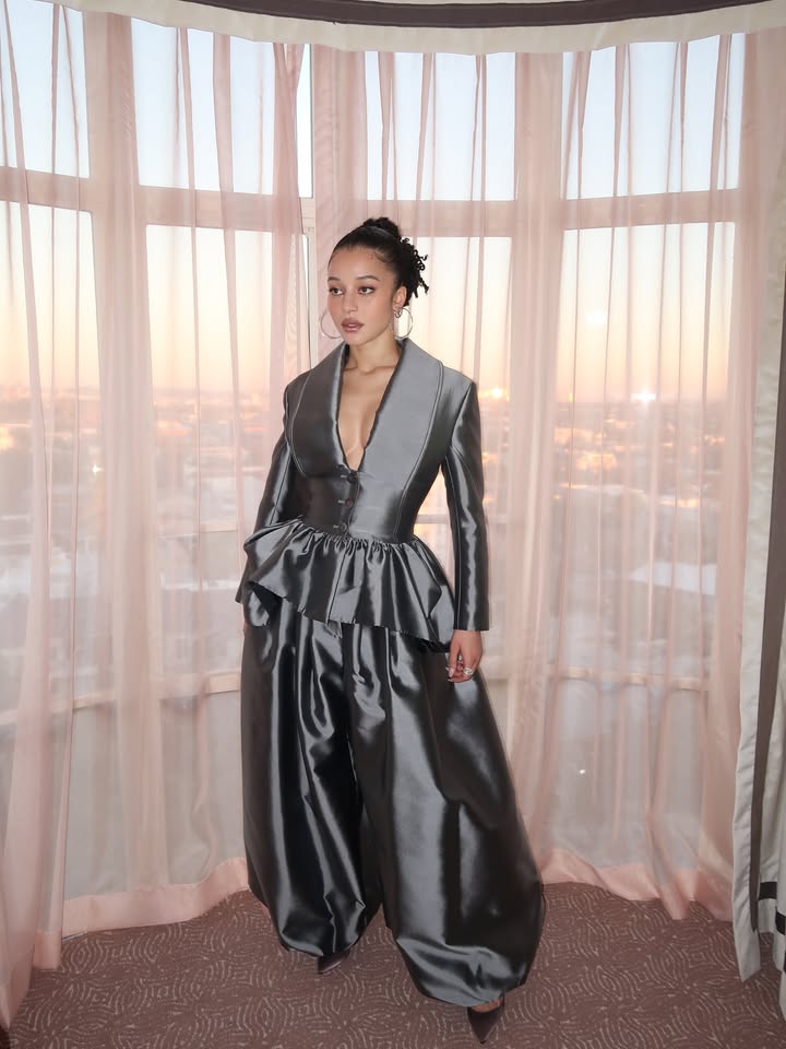 May be an image of gown, dress and text