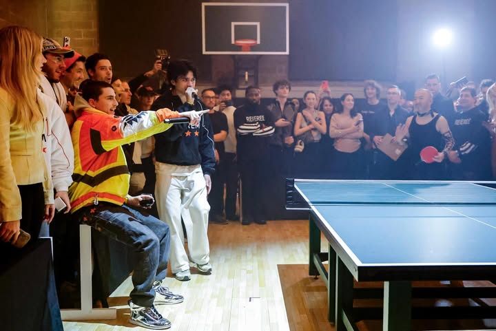 May be an image of racket, crowd and text