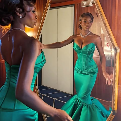 May be an image of gown, dress and text