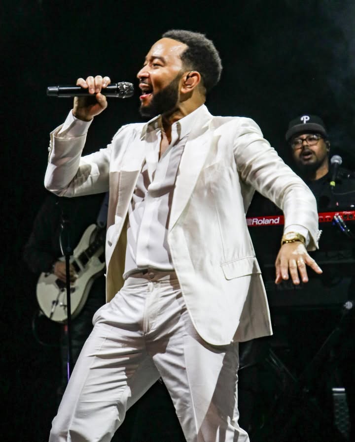 May be an image of blazer, microphone, concert and text