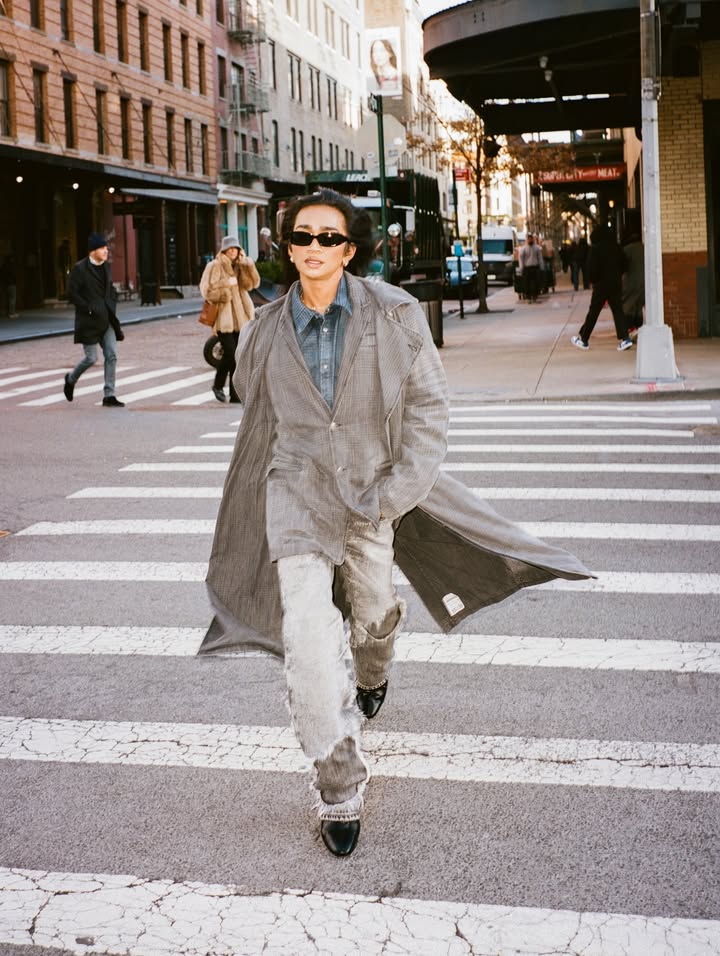 May be an image of overcoat, turtleneck, street and text