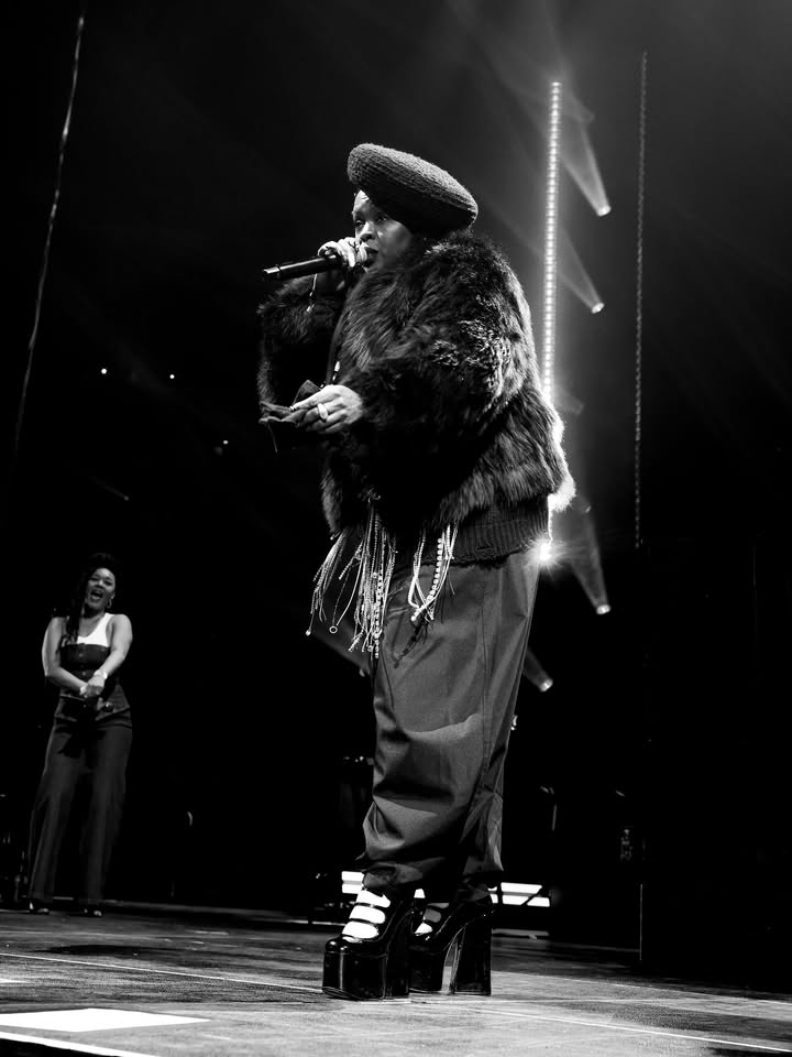 May be a black-and-white image of costume, microphone and text