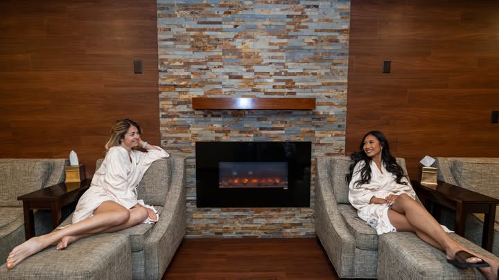 May be an image of one or more people, makeup, sleepwear, fireplace, robe, bath robe, hearth and text