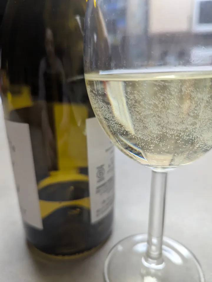 May be an image of wine, wine glass and text