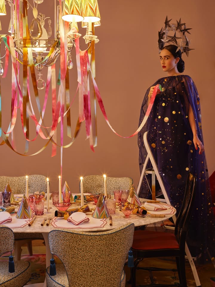 May be an image of candle holder, headdress, chandelier, lamp shade and text