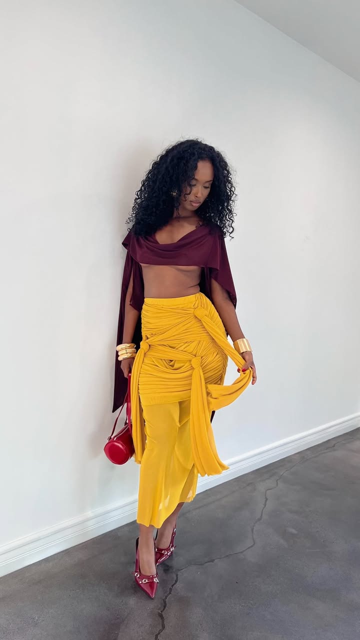 May be an image of skirt, miniskirt and text