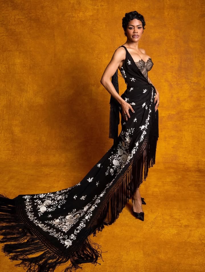 May be an image of sarong, dress, gown and text