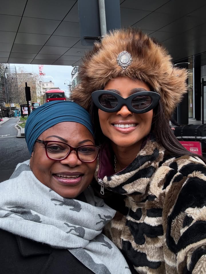 May be an image of one or more people, fur coat, eyewear, turban, head covering, headscarf, beret and text