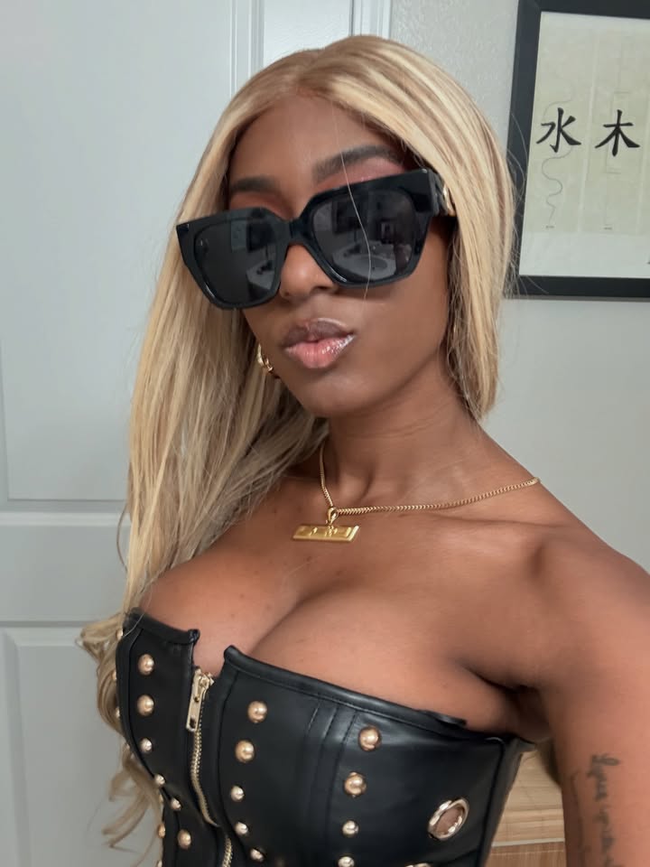 May be an image of one or more people, blonde hair, sunglasses and text