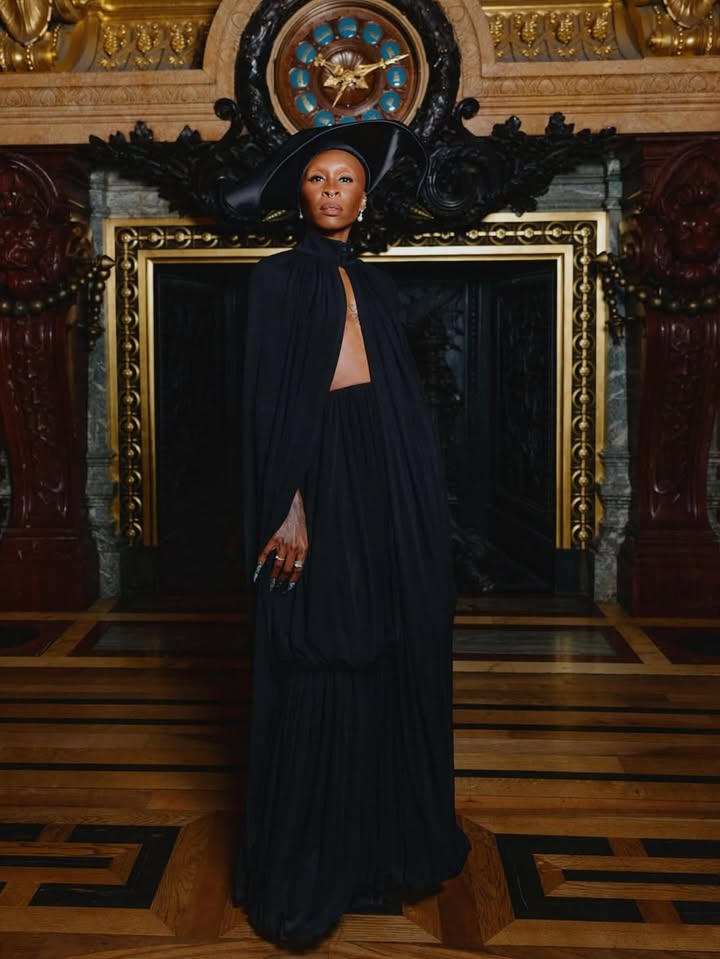 May be an image of gown, dress, headdress and text