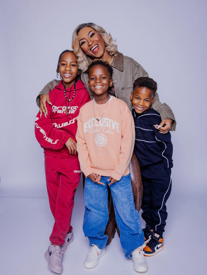 May be an image of child, smiling, sweatpants, sweatsuit, sweatshirt and text