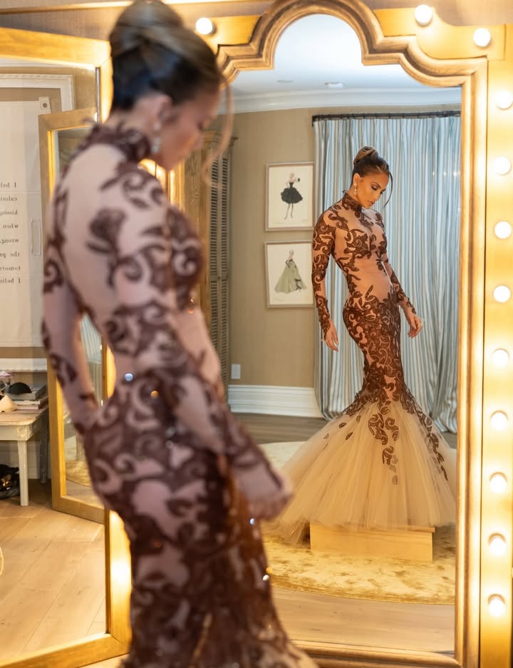 May be an image of gown, dress, mirror and text