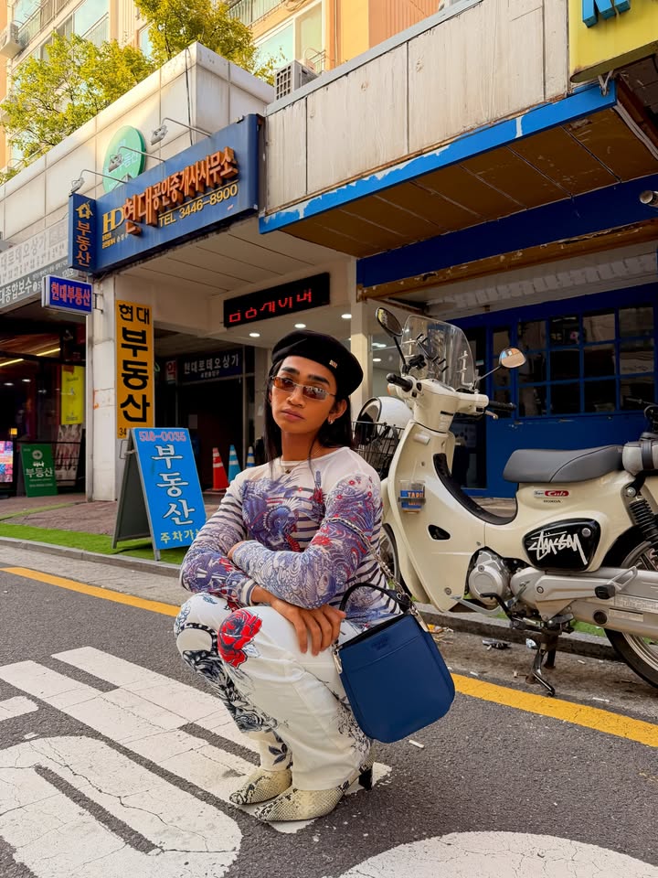 May be an image of turtleneck, beret, headscarf and scooter