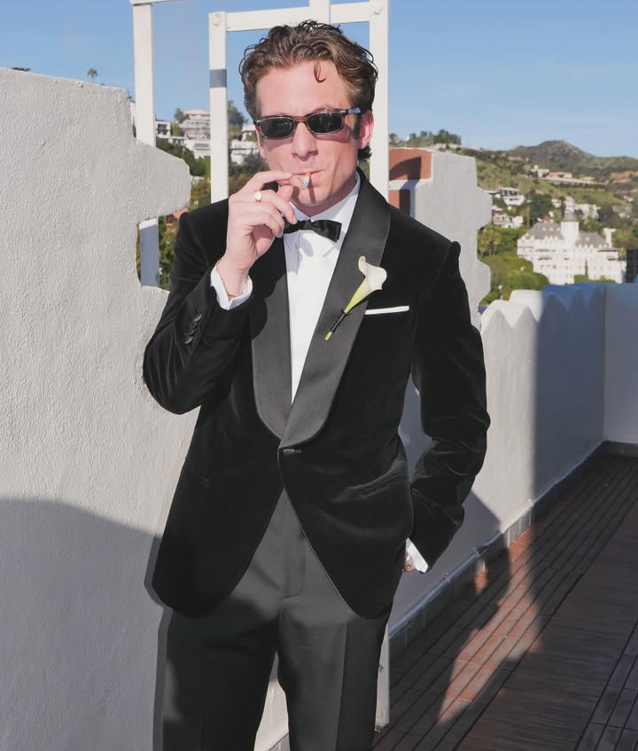 May be an image of suit, dinner jacket and text