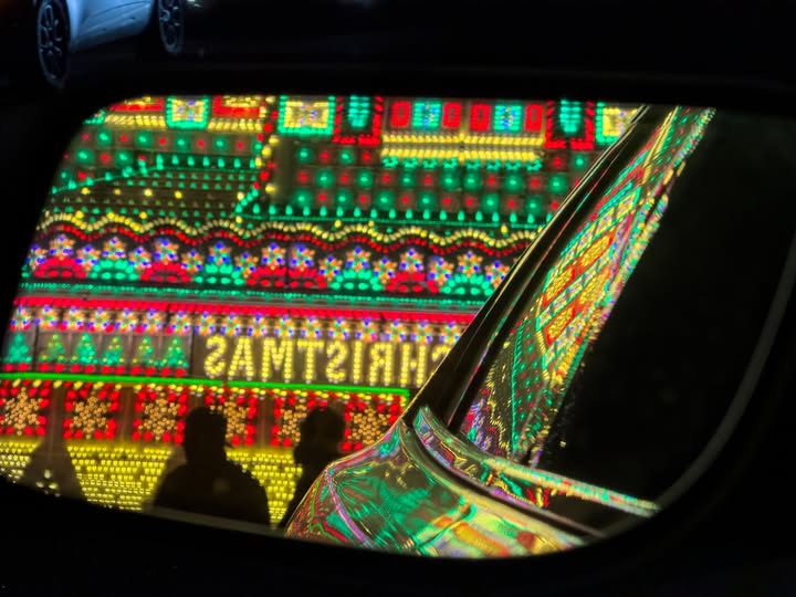 May be an image of rearview mirror, lighting, christmas tree, tinsel and text