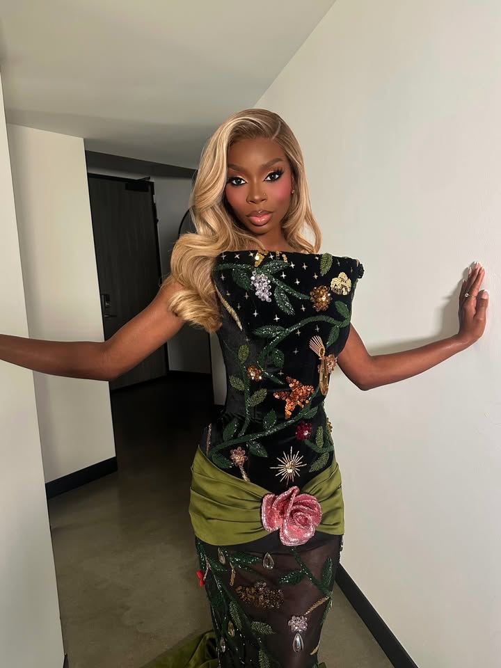 May be an image of one or more people, makeup, gown, dress and text