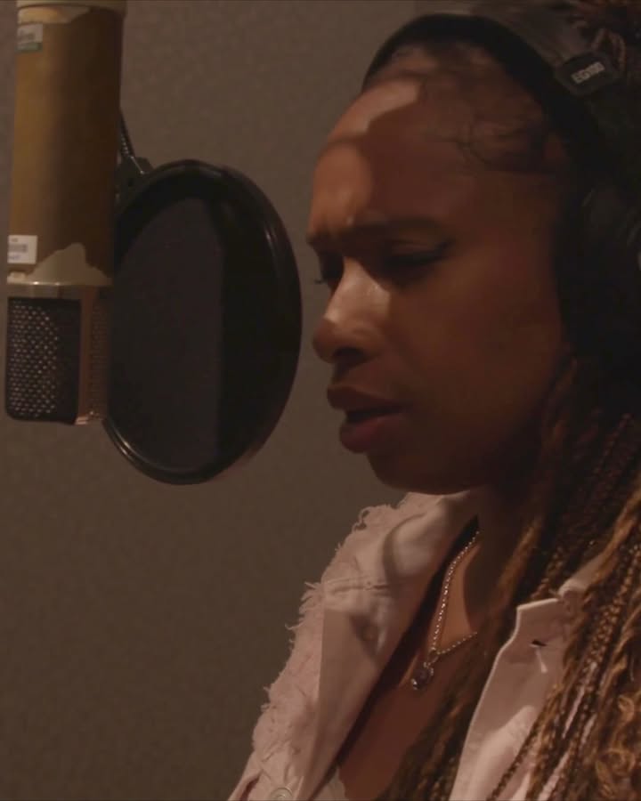 May be an image of one or more people, microphone and text