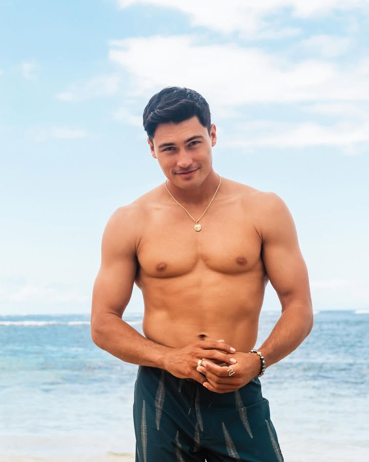 May be an image of one or more people, biceps, underwear, beach, ocean and text