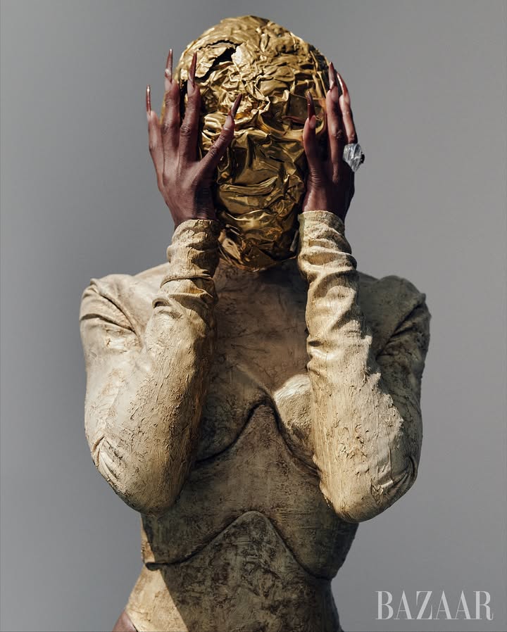 May be an image of magazine, headdress and bust