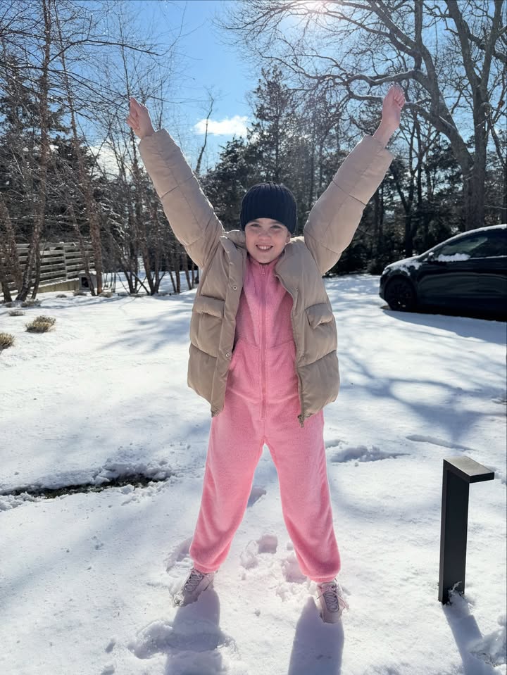 May be an image of snowball, snowsuit, snowman, sweatsuit, parka, snow and text