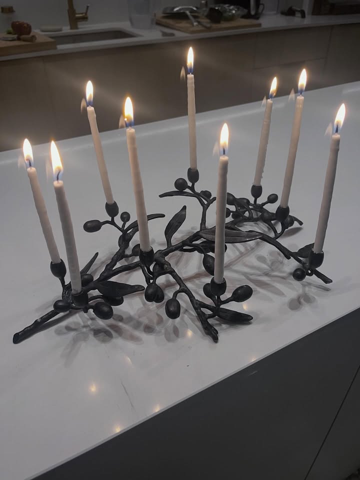 May be an image of candle holder, candle and text