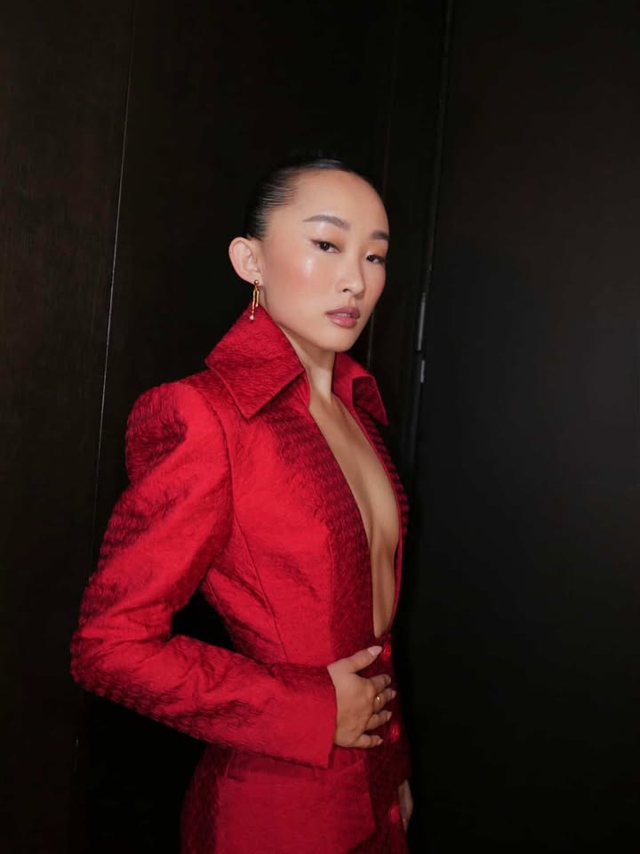 May be an image of one or more people, makeup, suit, blazer and text