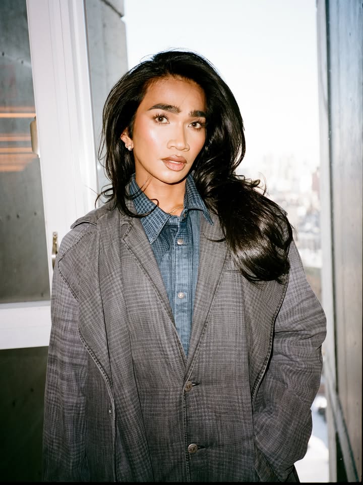 May be an image of one or more people, makeup, duffle coat, overcoat, turtleneck and text